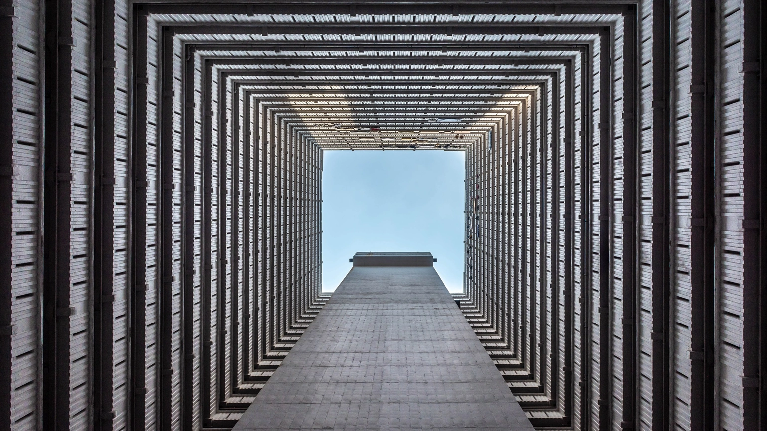 The low angle shot of a high-rise modern building