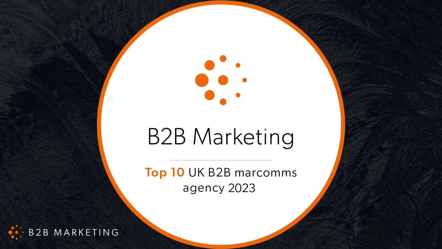The text 'B2B marketing Top 10 UK B2B marcomms agency 2023' sits on a white circle outlined in orange on a black background