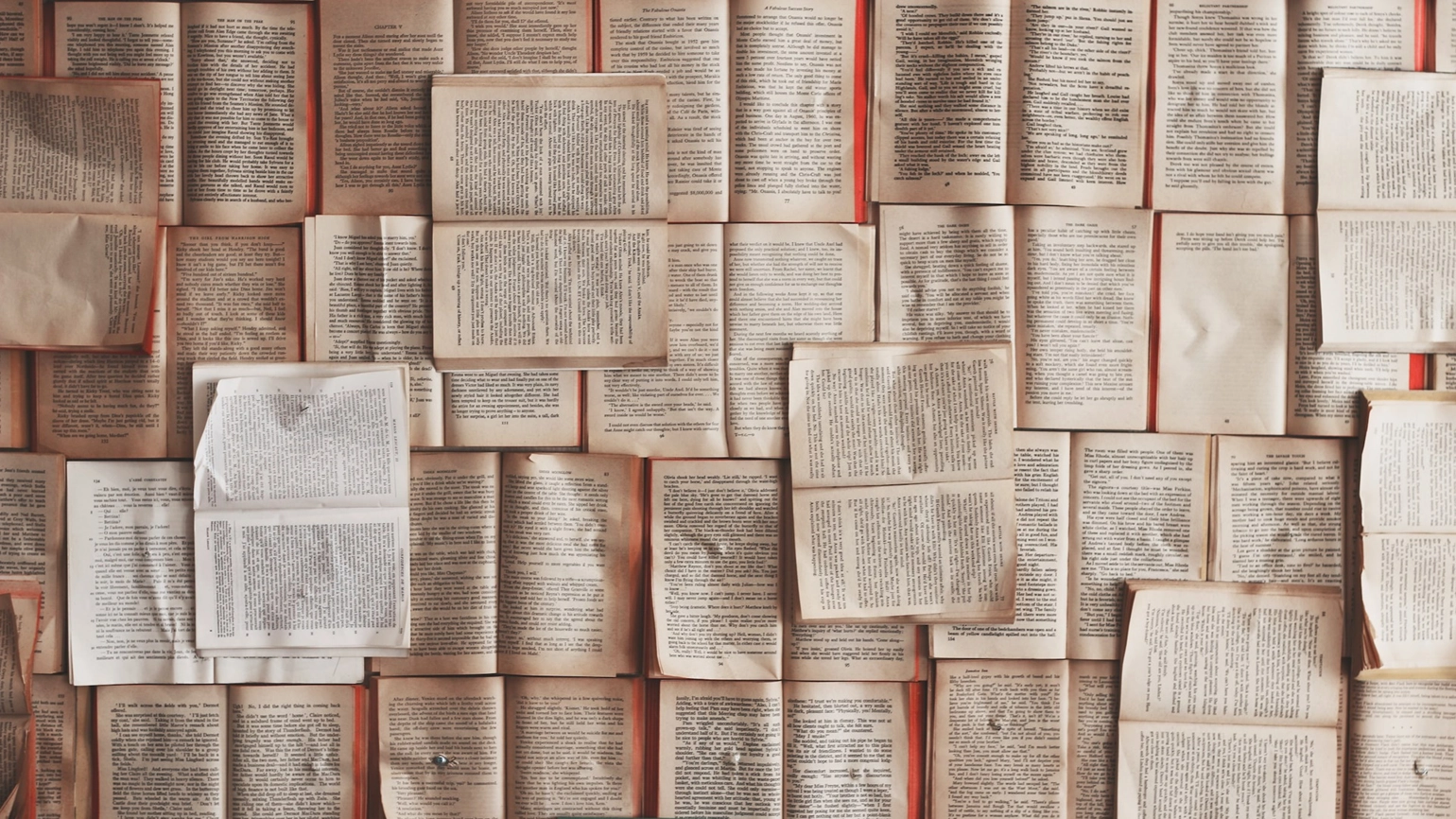 A lot of books being opened on a flat surface