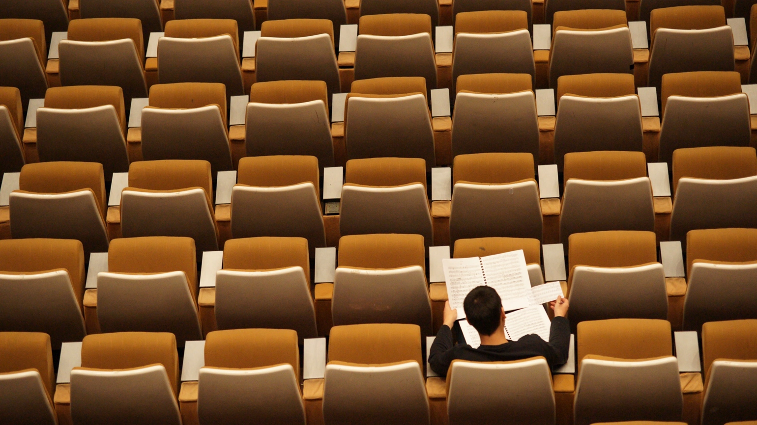 A student studying in a lecture hall